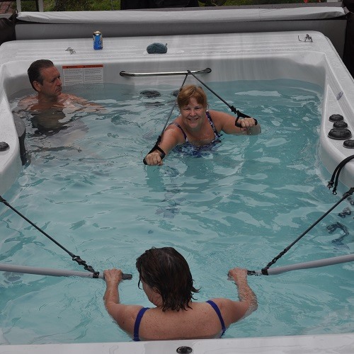 people in physical therapy exercising in a hot tub